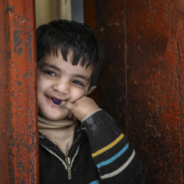 Five year old Abdullah shows the ink mark that confirms his Polio vaccination in Pakistan