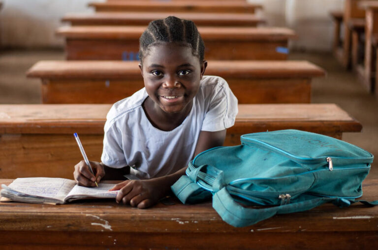 Child with UNICEF rucksack in a classroom