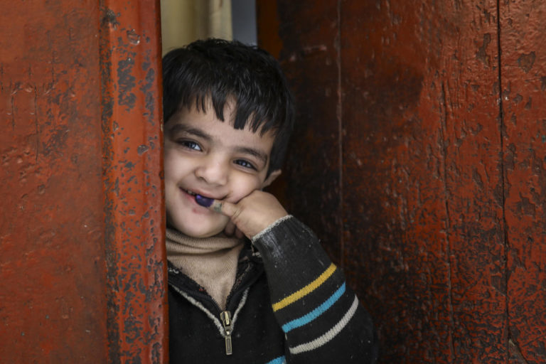 Abdullah (5) shows ink mark on his little finger, which confirms that he has received polio vaccine during Polio – National Immunisation Day (NID) in Bhatti gate area of Lahore Punjab Province, Pakistan