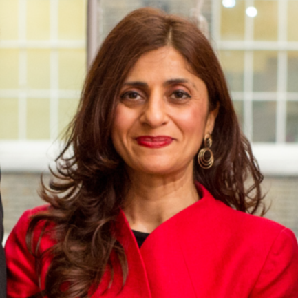 Image of UNICEF trustee Zamila wearing a red blazer and smiling.