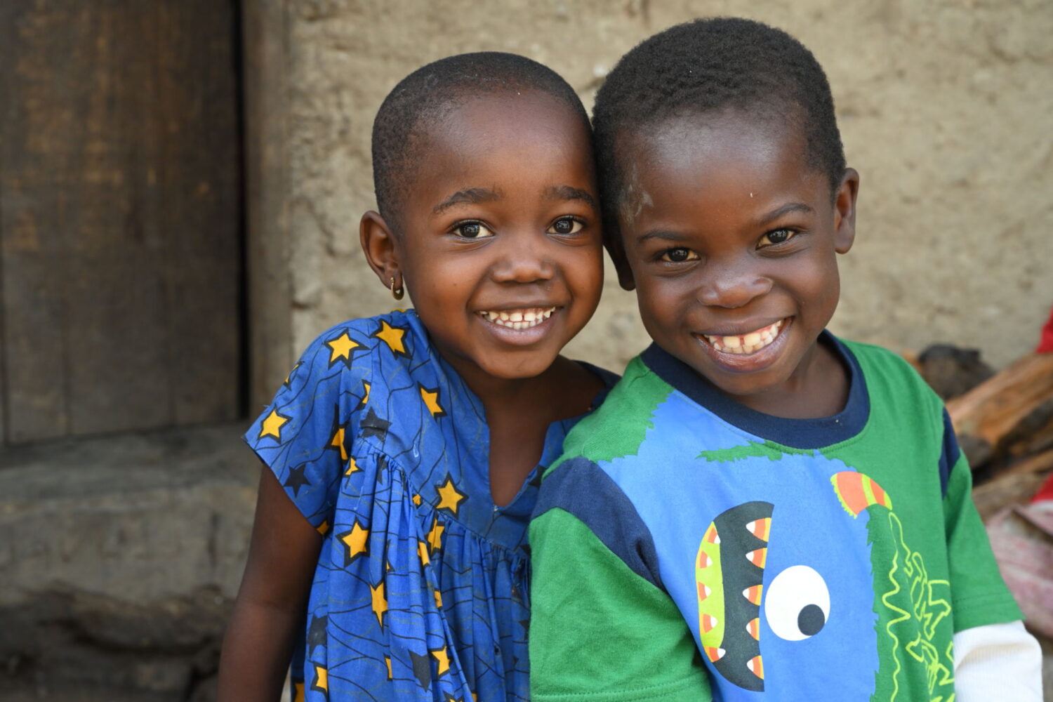 Two children smiling together in Santchou, in the West of Cameroon.