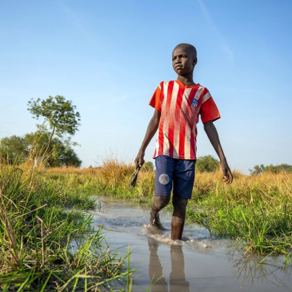 13 year old Panyagor But wades through flood water in the village of Panyagor in Twic East, Jonglei State in South Sudan.