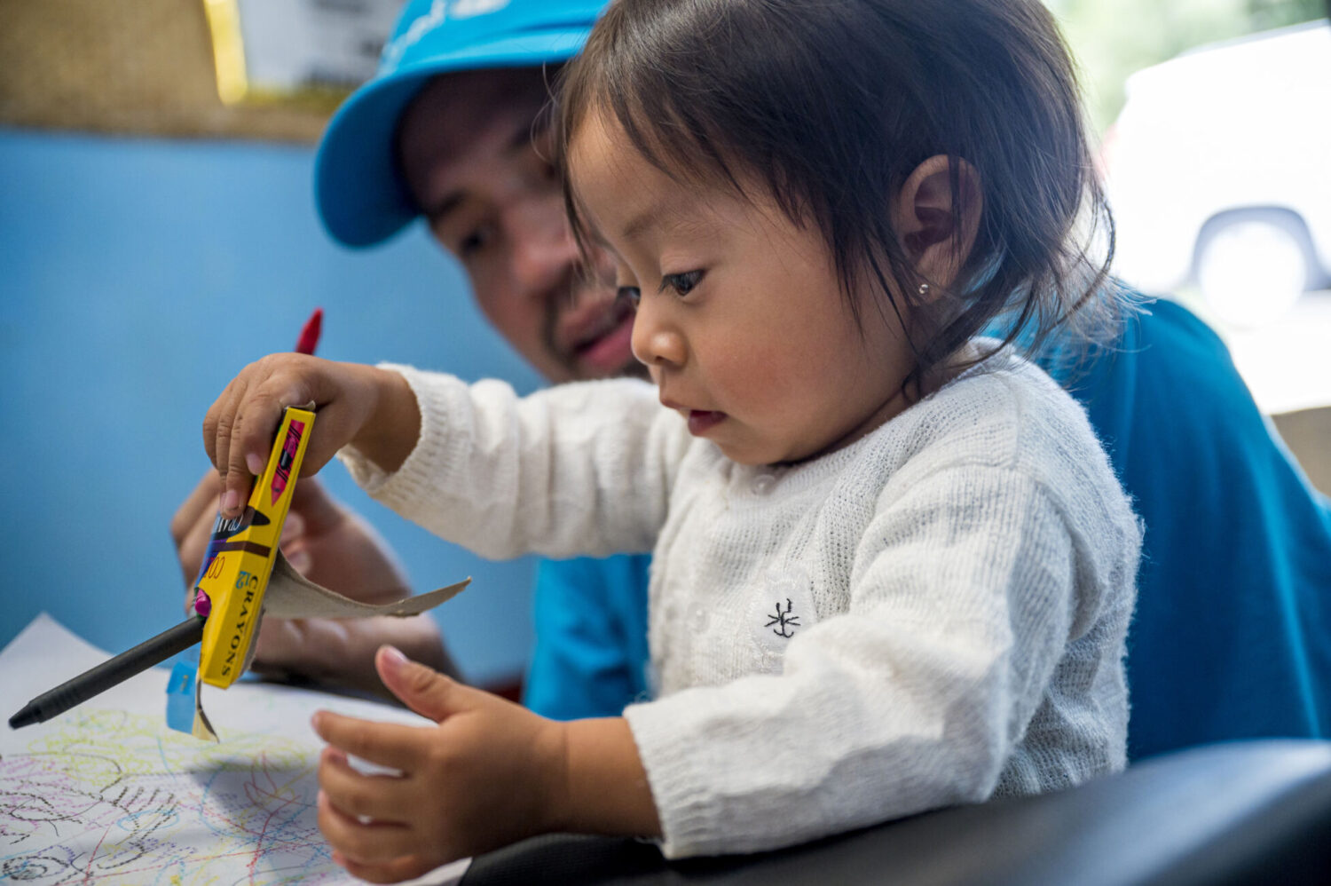 Mario Valdez (UNICEF) playing with Maria (1.5 months) before she is vaccinated in Buena Vista health center in Chimaltenango on March 29, 2023.