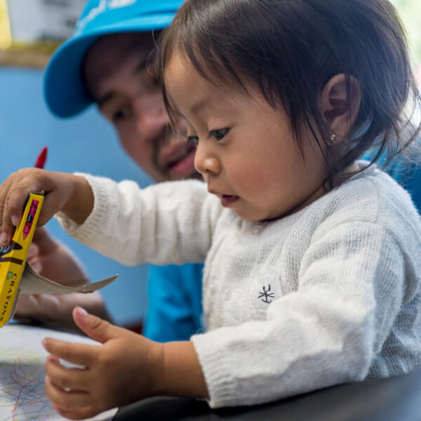 Mario Valdez (UNICEF) playing with Maria (1.5 months) before she is vaccinated in Buena Vista health center in Chimaltenango on March 29, 2023.