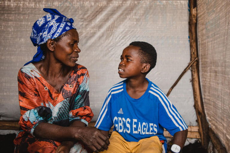 12 year old Patricien with his grandmother fled DRC