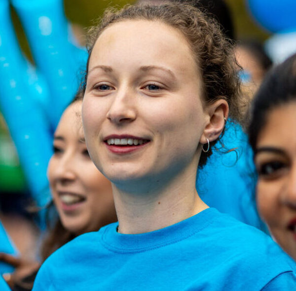People cheering on UNICEF runners at an event.