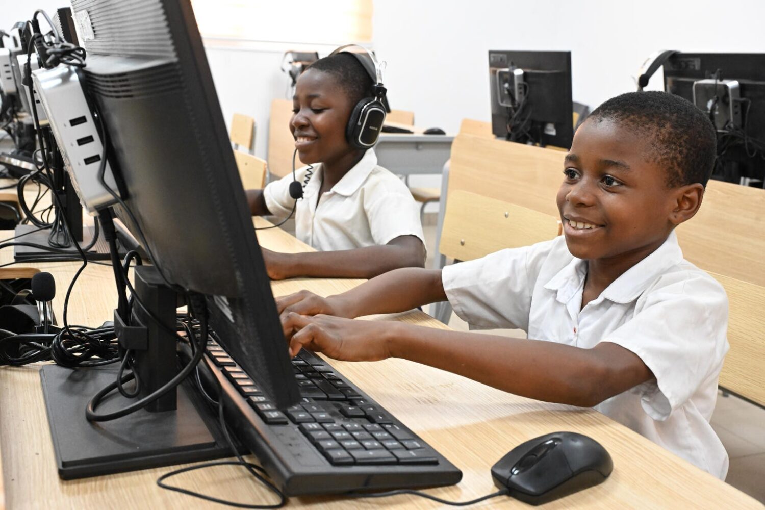 Two students working on computers in southern Côte d'Ivoire.