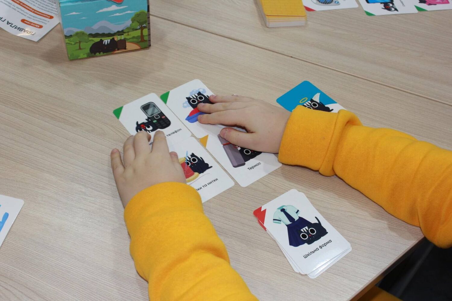A child playing with a game of cards.
