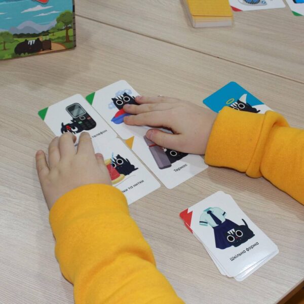 A child playing with a game of cards.
