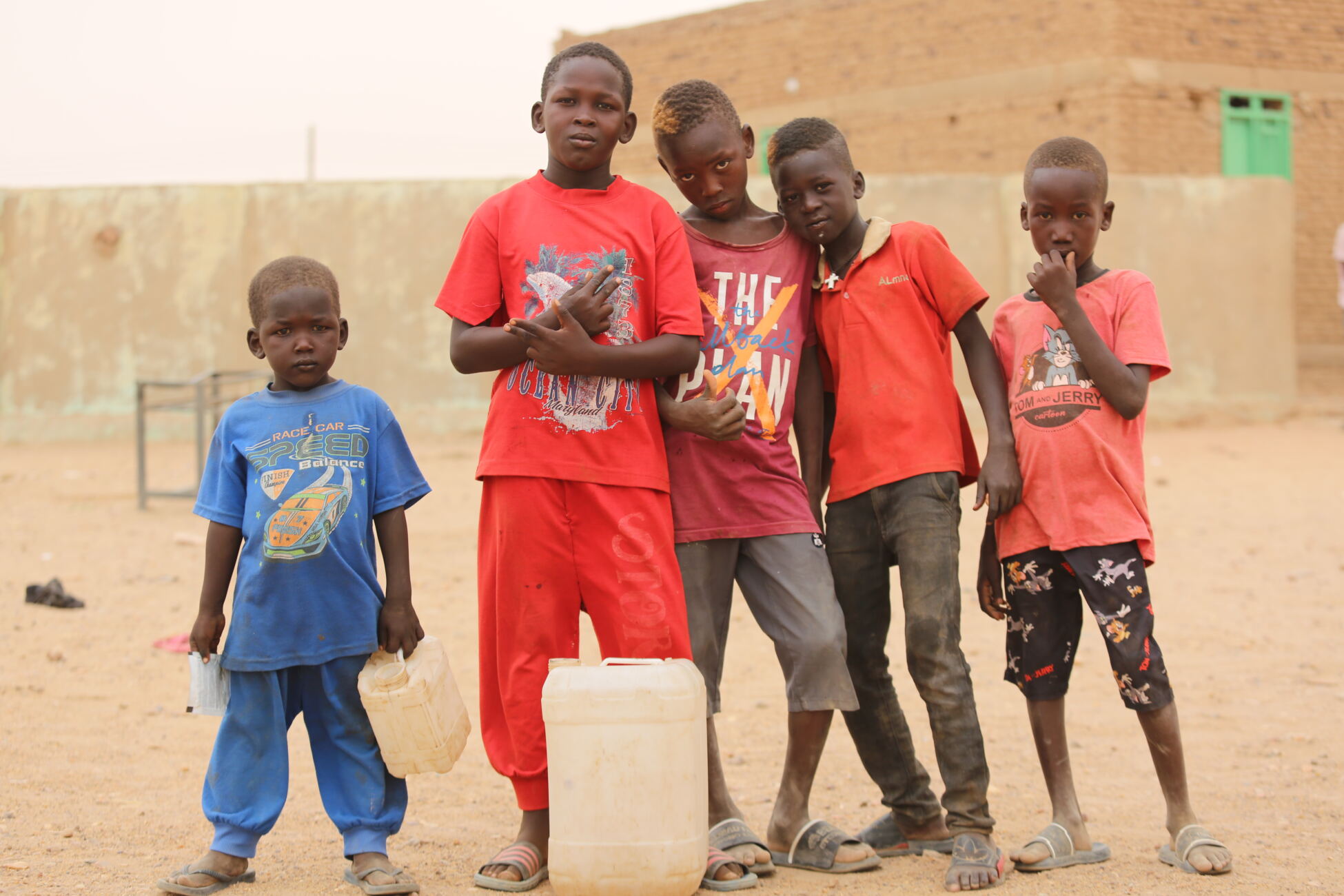 A group of displaced children stand together in Atbara, Sudan.