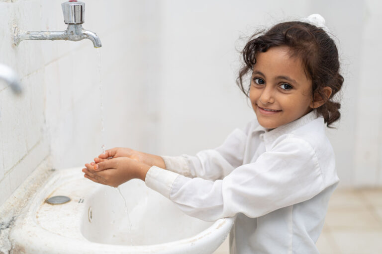 Zainab, a 9-year-old third grader, washes her hands in Fatima Al Zahra primary and secondary school restrooms in Khanfir District, Abyan Governorate, Yemen.