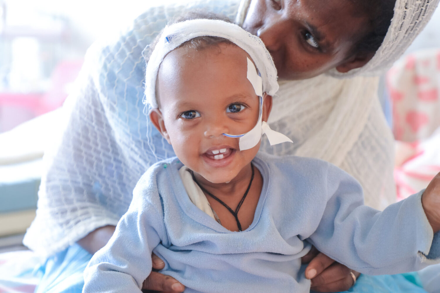 A child from Ethiopia, Tigray smiles in a hospital where he is being treated for severe acute malnutrition.