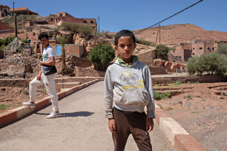 A child stands in front of his village near Tahanaout in the Atlas Mountains of Morocco, that was destroyed by a major earthquake.