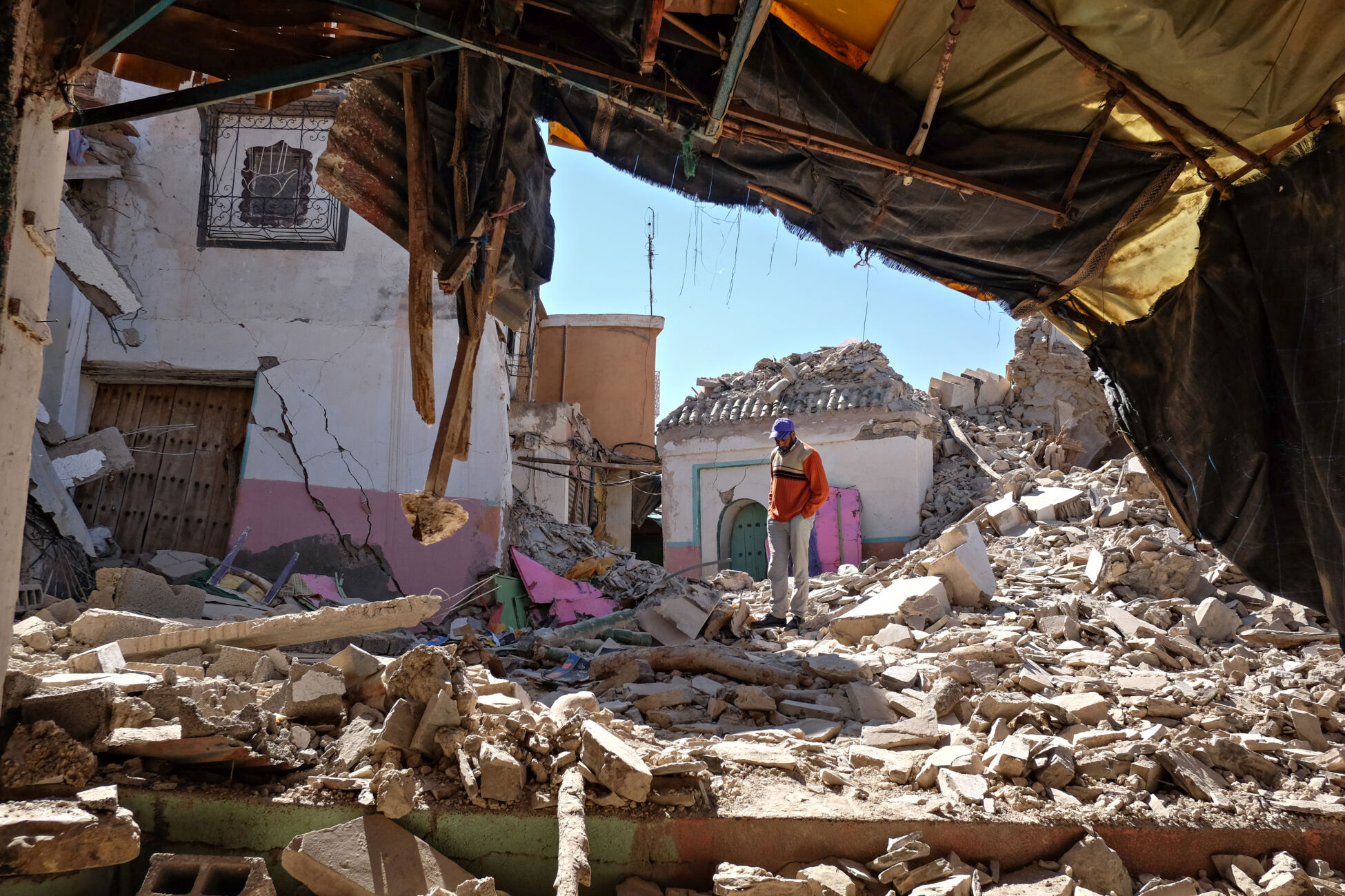 A man looks at what remains of the small city of Moulay Brahim that was destroyed by a major earthquake that hit Morocco.