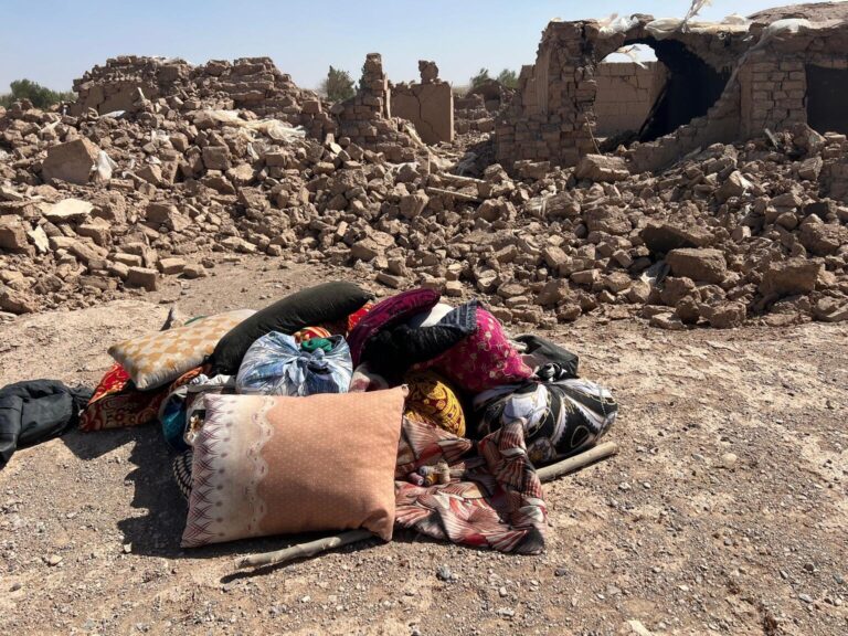 A small pile of a family's belongings sits outside the rubble of their home which was destroyed by the recent earthquake.
