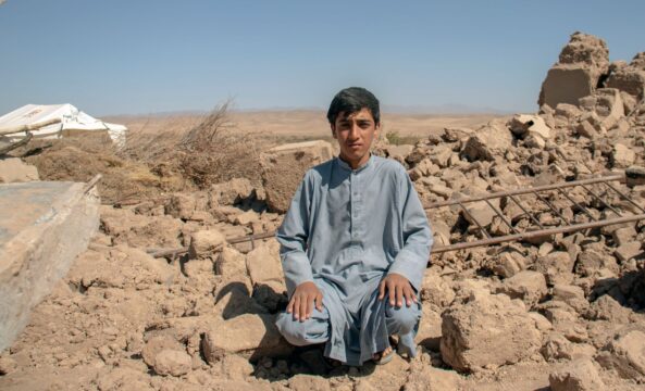 Lobair aged 14 sits among the rubble following earthquakes in Herat Province, Afghanistan