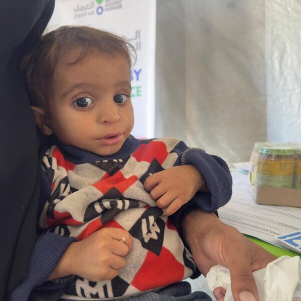 1-year-old Ali in the arms of his mother Eman.