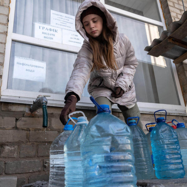 12 year old girl visits her former school to collect drinking water.