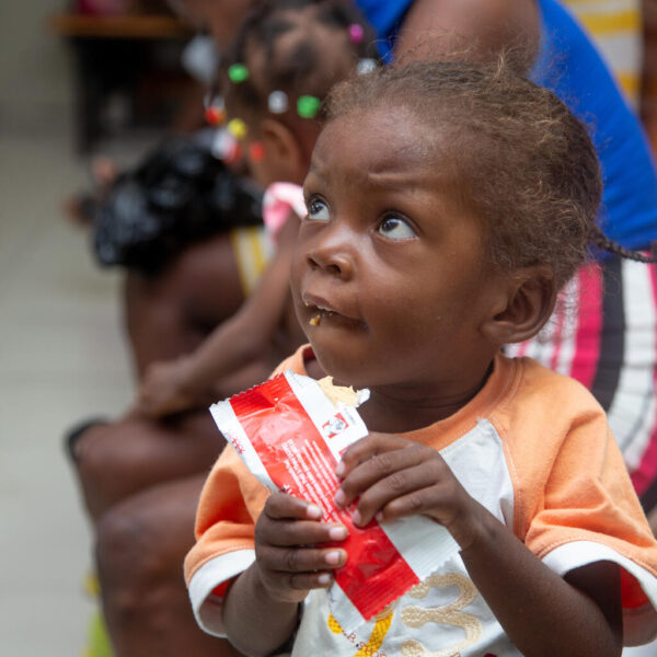 A child eats a sachet of ready-to-use food.