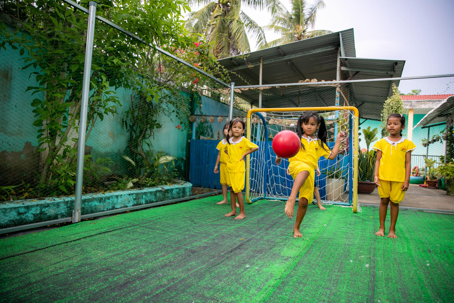A 5-year-old girl playing football with her friends in Vietnam.