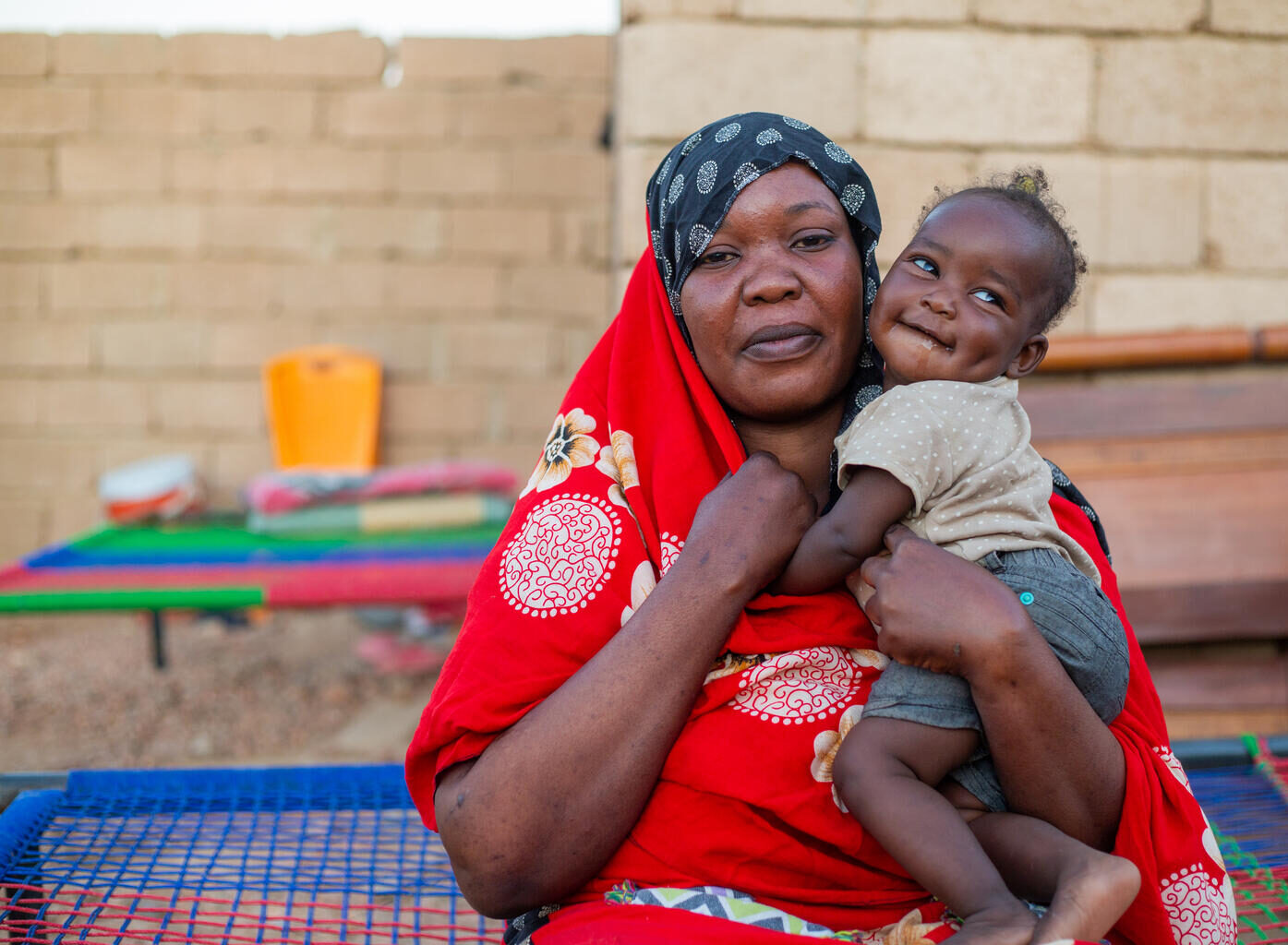 A mother holds her young daughter close to her chest in Sudan.