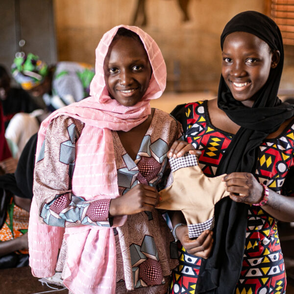 Fatoumata Diallo 17 years old, 7th grade class and Mampi dabou 16 years old, 9th grade class show a handmade sanitary pad.