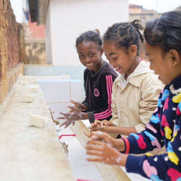 Girls are washing their hands.