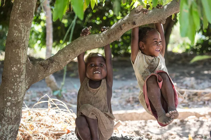 Lala Soa, 5, and Kristavine, 5, play in the vegetable garden in Berano, deep south, Madagascar.