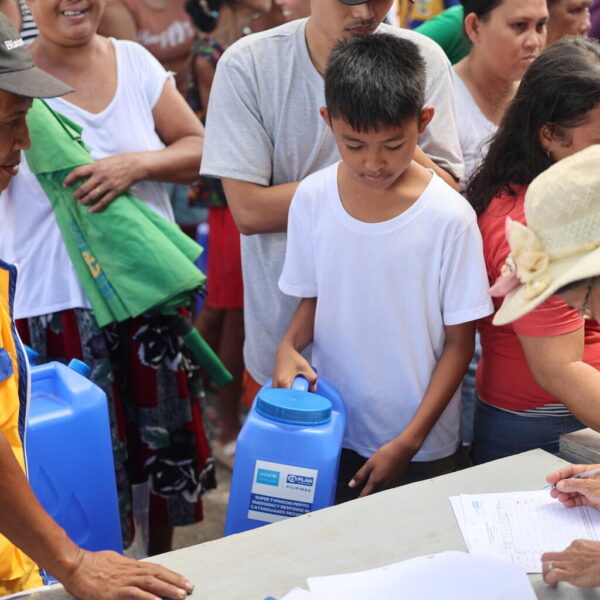 A boy in the Philippines queues for water.