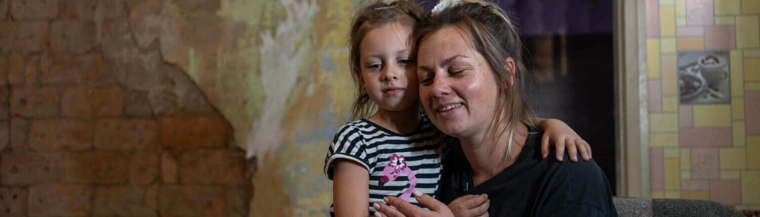 a mother hugs her daughter
