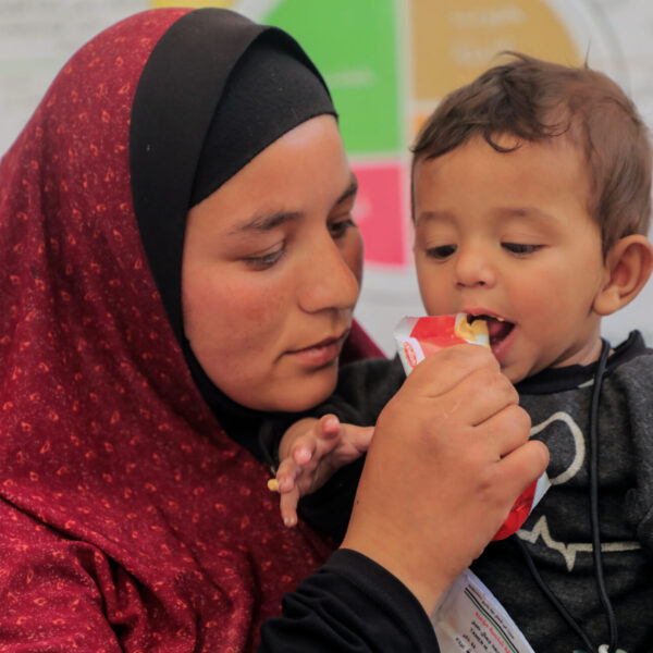 9-month-old Abdul Kareem is being fed therapeutic food by his mother Enan at a UNICEF-supported malnutrition screening and treatment point in North Gaza.