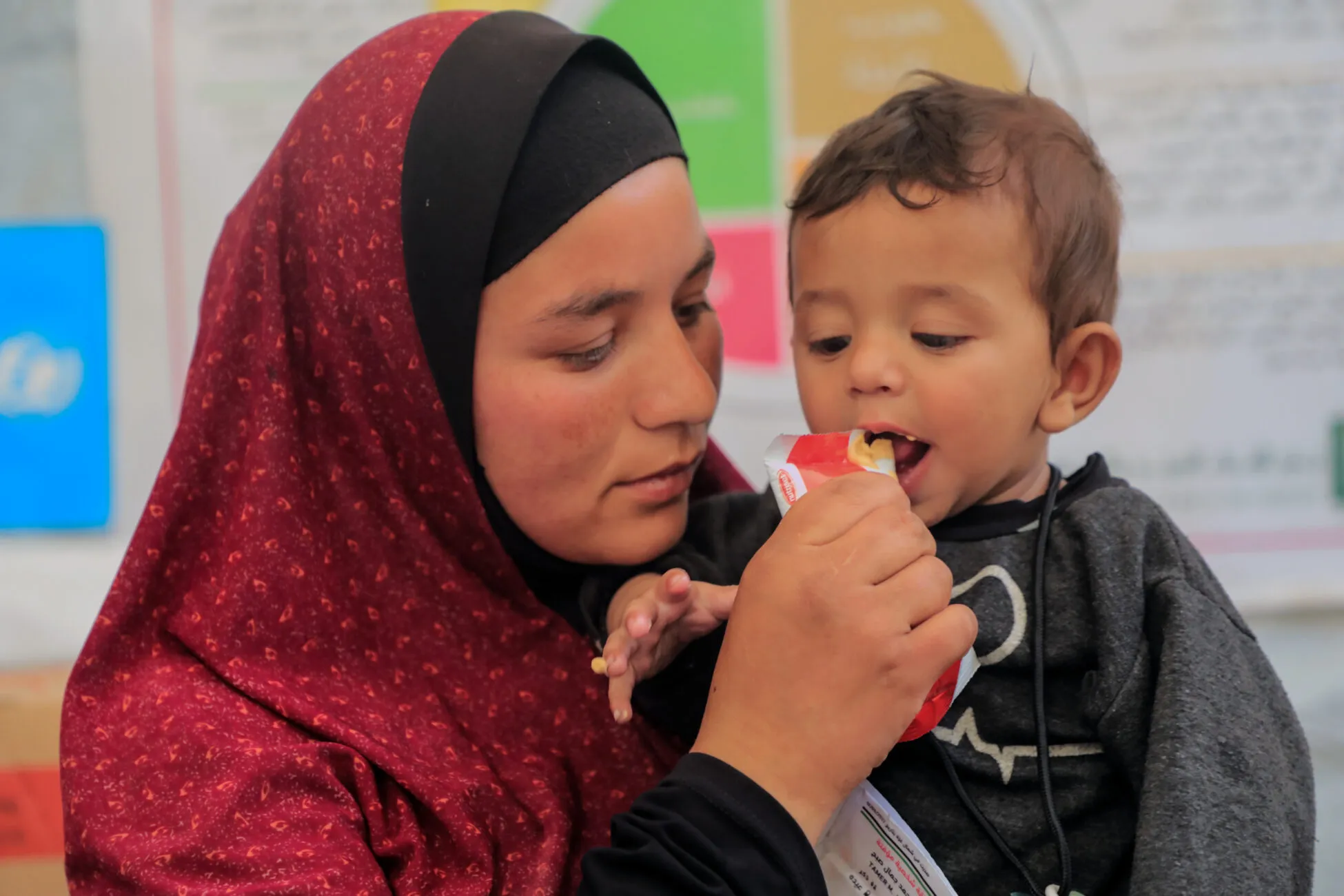 9-month-old Abdul Kareem is being fed therapeutic food by his mother Enan at a UNICEF-supported malnutrition screening and treatment point in North Gaza.