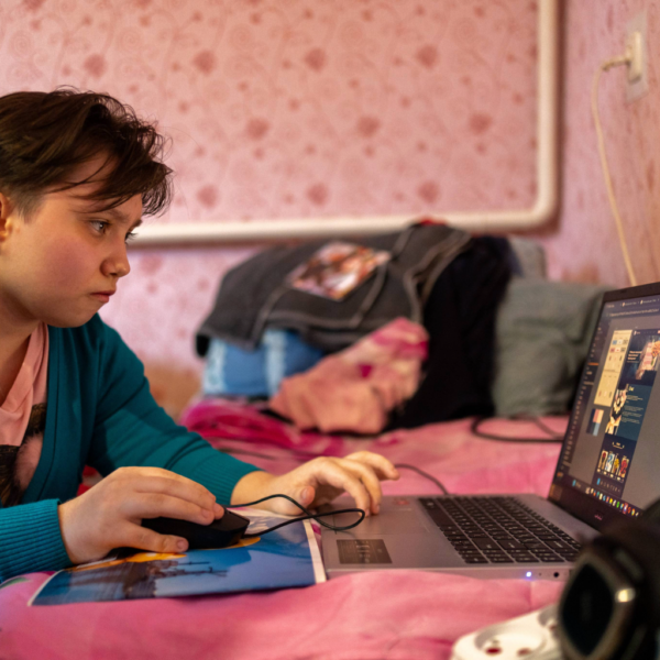 Daryna, 18, in Synelnykove, Ukraine, works on her laptop from her bed. She is working on a graphic design project.