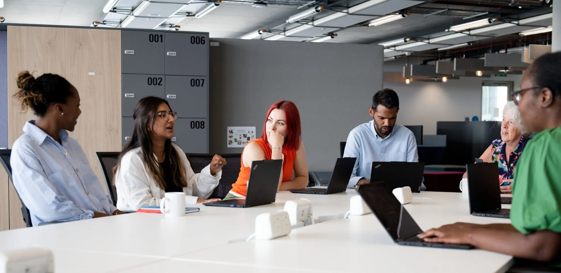 employees at UNICEF UK sitting and talking to each other.