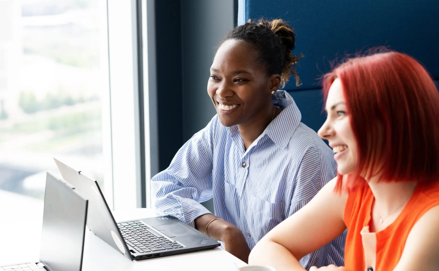 two female employees from UNICEF UK smiling