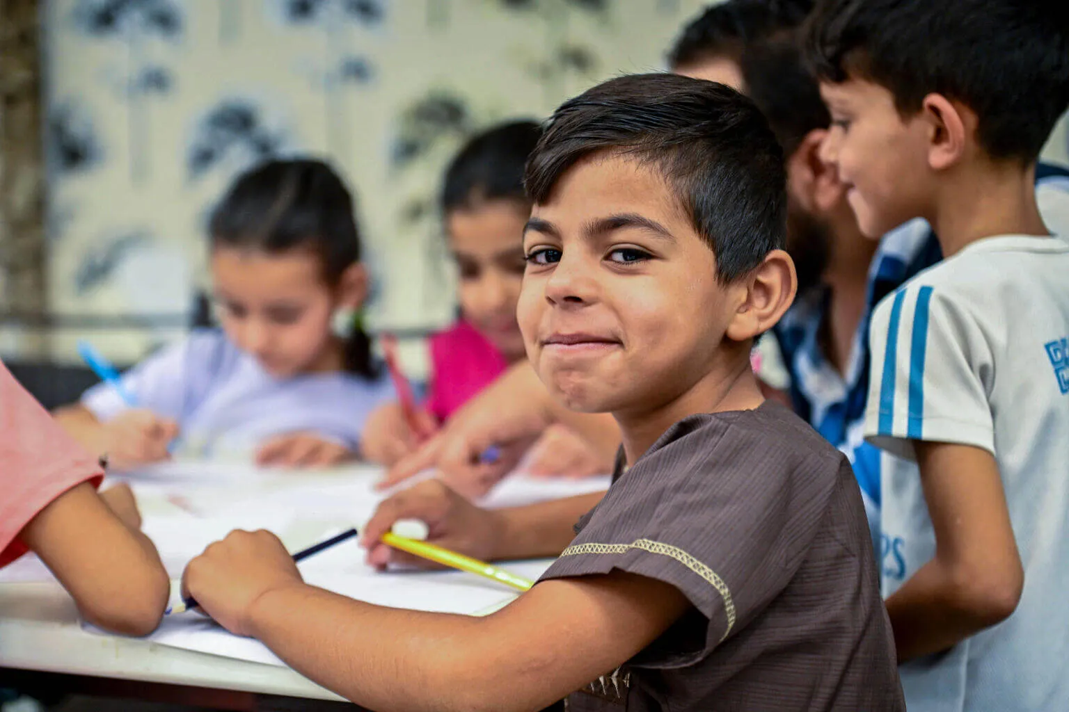 Anas, 8, takes part in a drawing activity provided by a UNICEF-supported child protection team at a shelter in Sayyeda Zeinab, Rural Damascus, Syria on 2 September 2025.