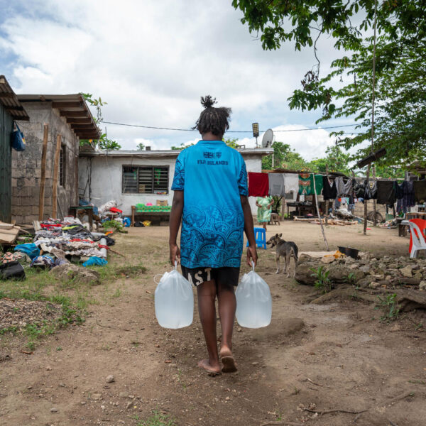 Children in Mele Maat Village returning home with water filled in collapsible containers from UNICEF Vanuatu.