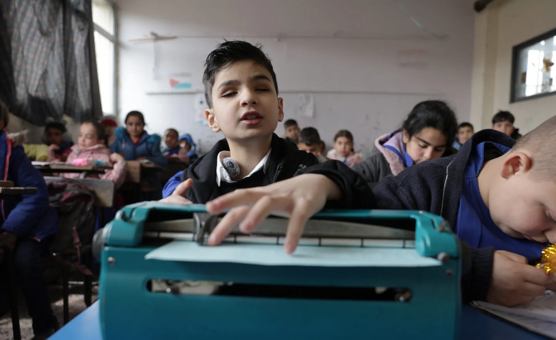 Youssef is using a Braille machine at school.