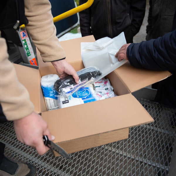 Volunteers unpack hygiene kits for the residents of Podlyman, Ukraine - including washing powders, soap, adult and children's diapers, pads, shampoos, towels.