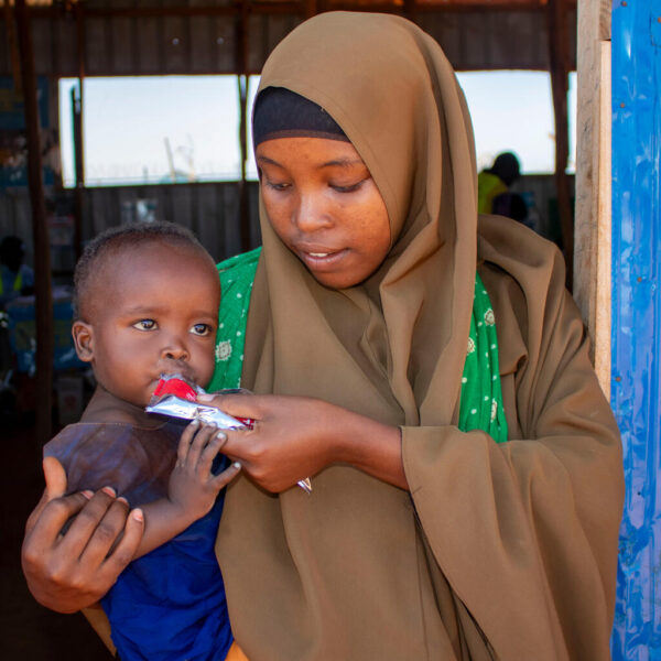 Fahia, seven months old, is in her fourth week of treatment for severe acute malnutrition, supported by her mother, Ahado.