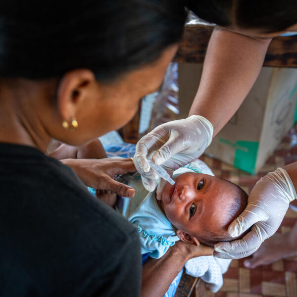 Nurses from Faleolo Hospital administer vaccinations during a mobile vaccination session at a village in Samoa, bringing essential healthcare to the community.