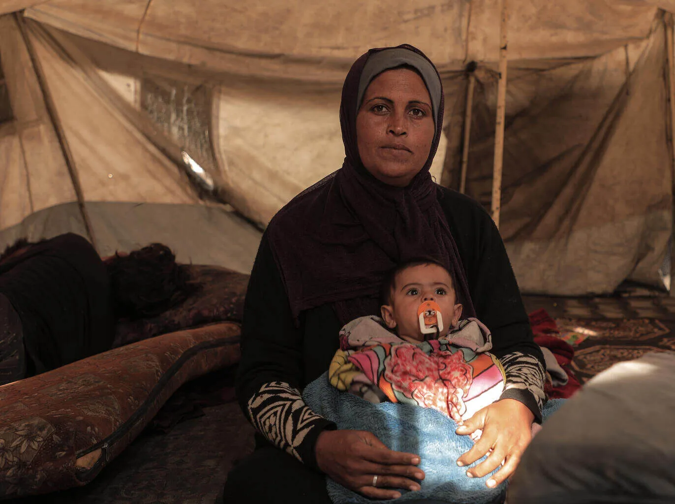 Sherihan is holding her six month old grandson, Mohammed.