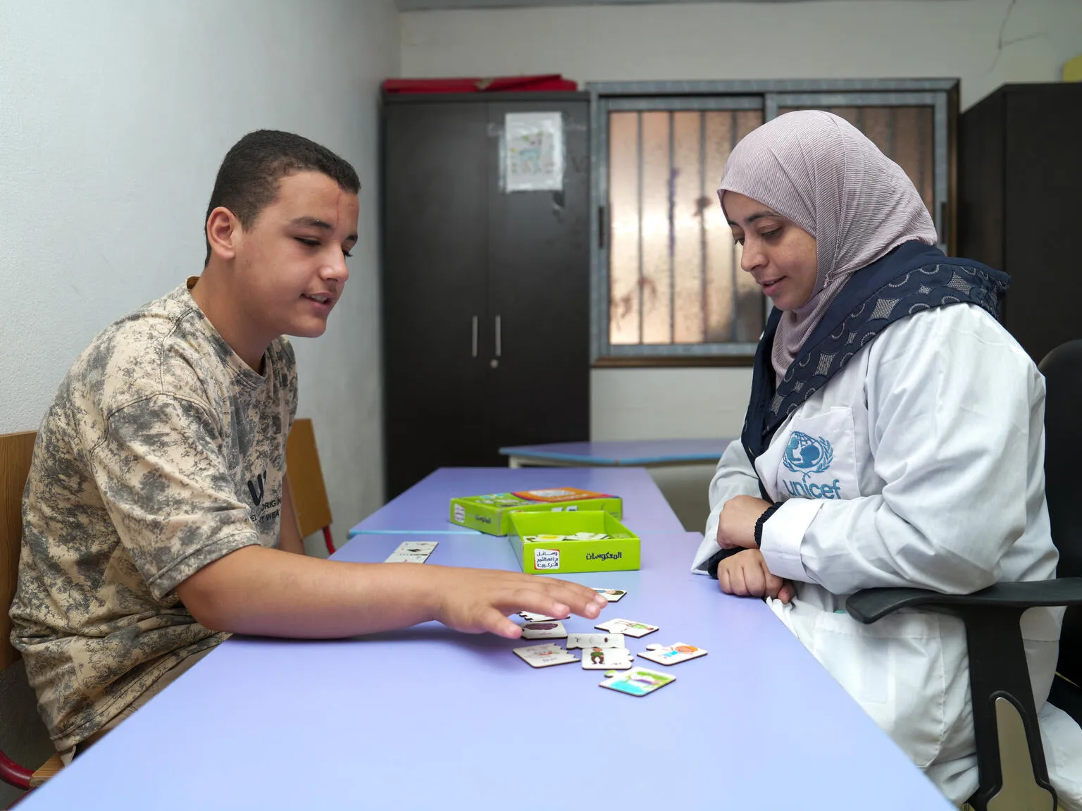 Majd plays an educational game with his teacher at a UNICEF-supported self-learning centre for children with disabilities in Dar’a city, Syria, on 14 September 2025.