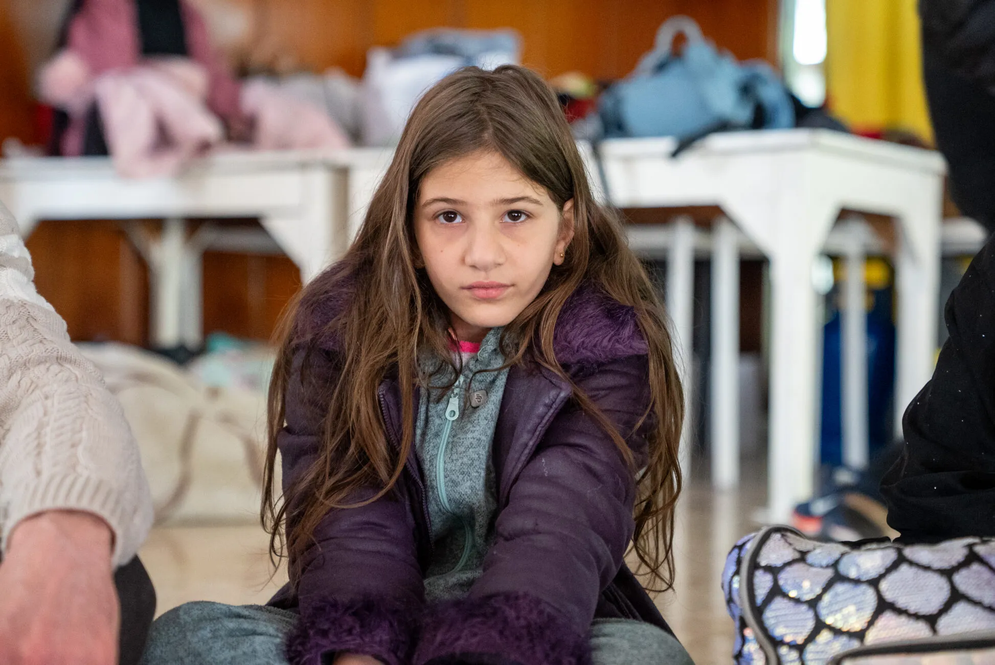 Zeinab, 12, sits in public school turned into a shelter.