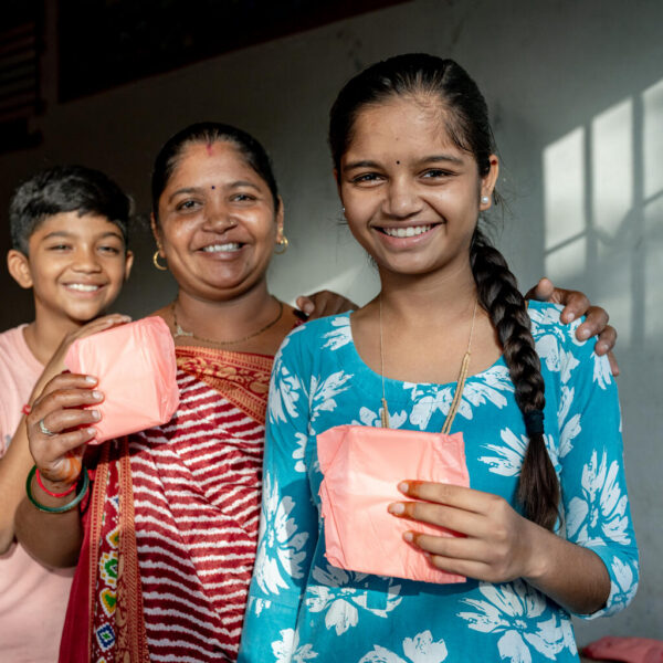 A family holding menstrual pads