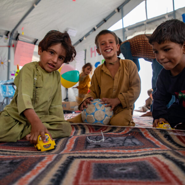 Sajedullah, Tamim, and Huzaifa playing together at Child Friendly Space in a camp in Afghanistan.