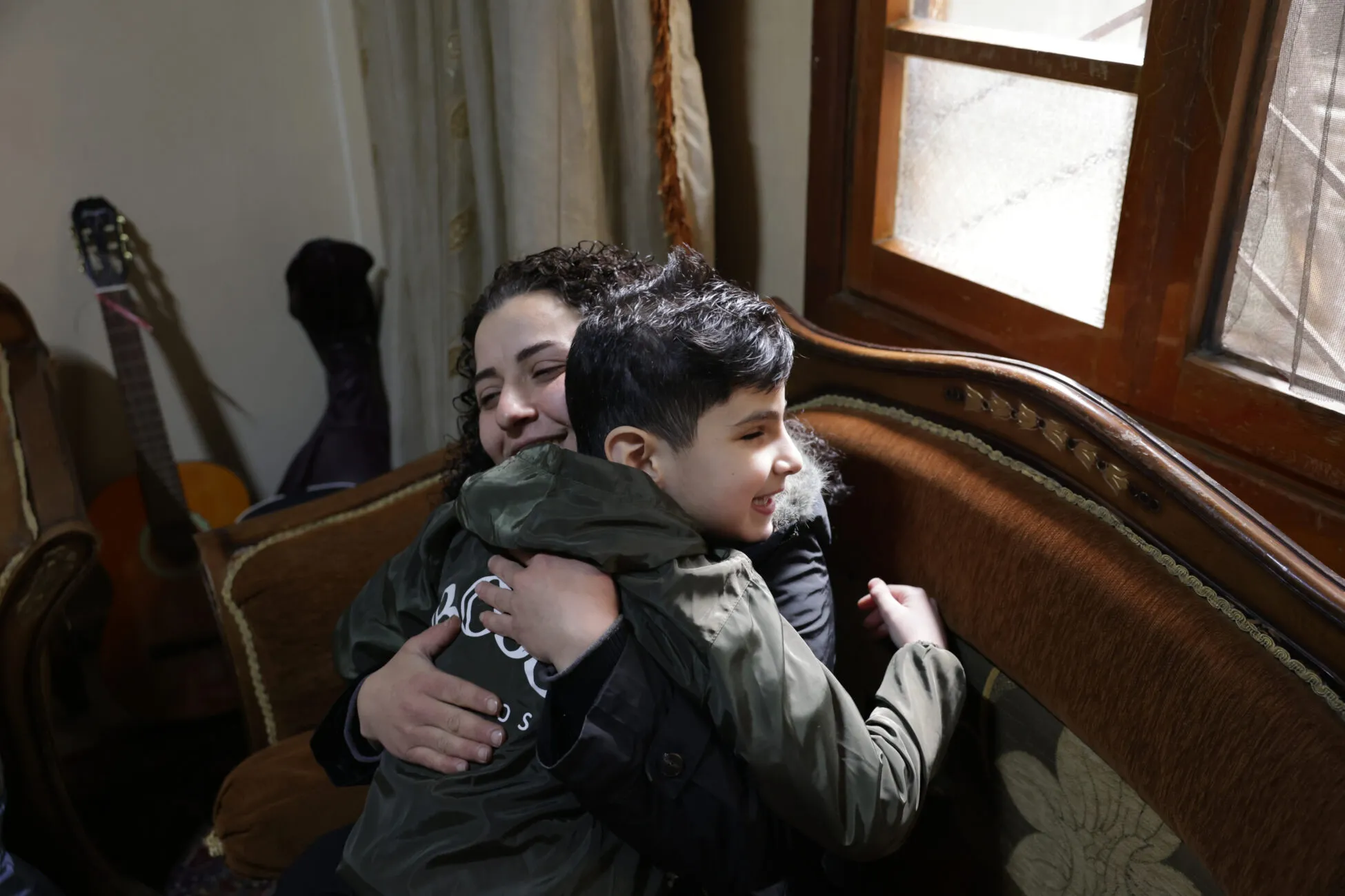 Vision impaired eight-year-old Youssef gives his mum a tight hug before they both head off to school in Syria.